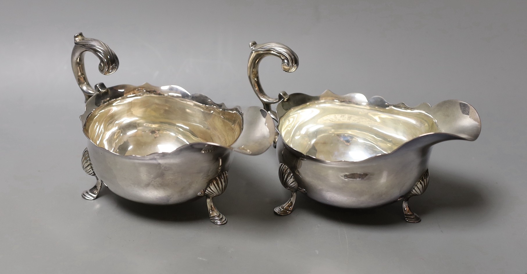 A pair of Georgian silver sauceboats, with flying scroll handles, marks rubbed, length 17cm